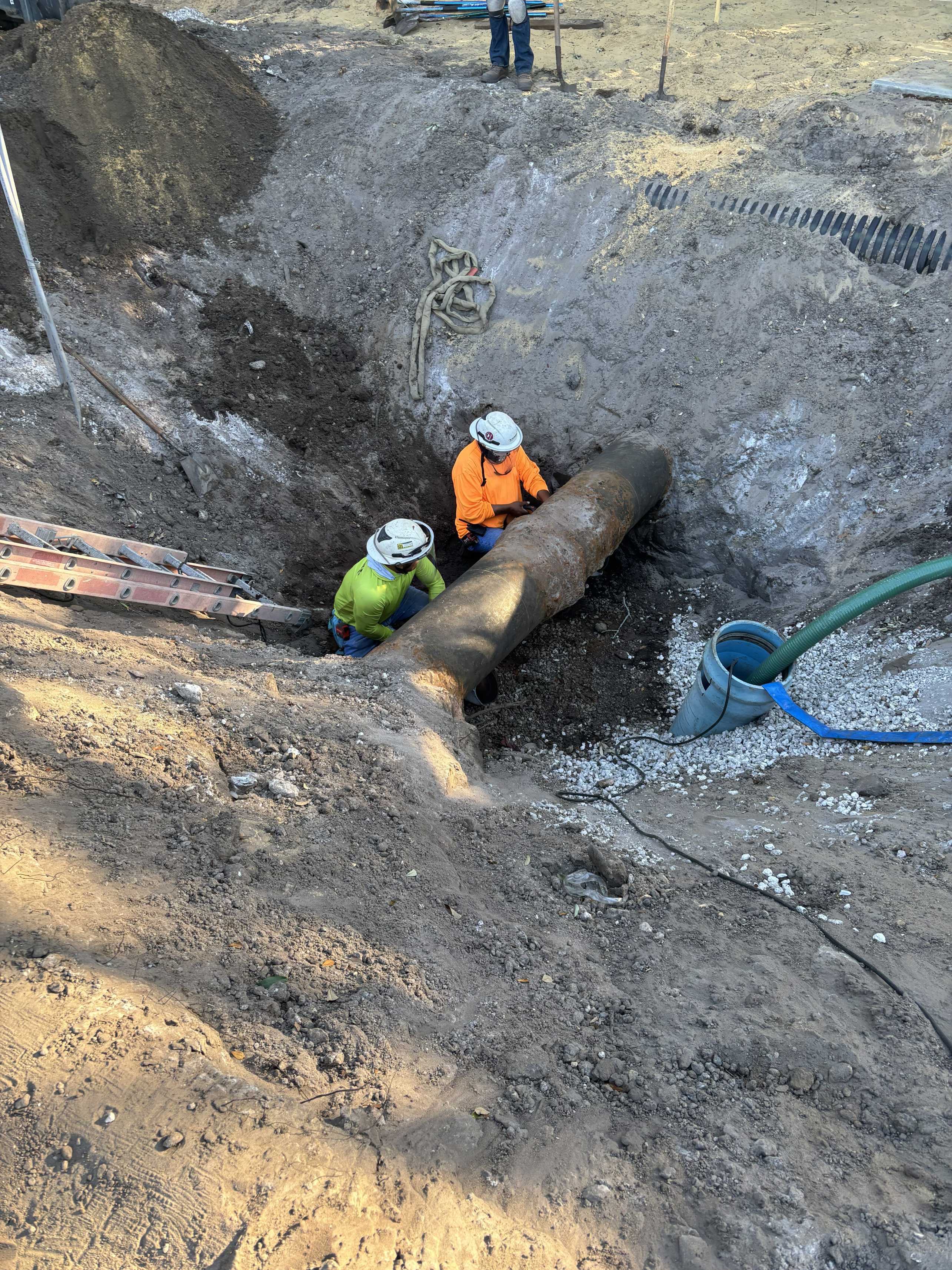Two Employees Working on Pipe