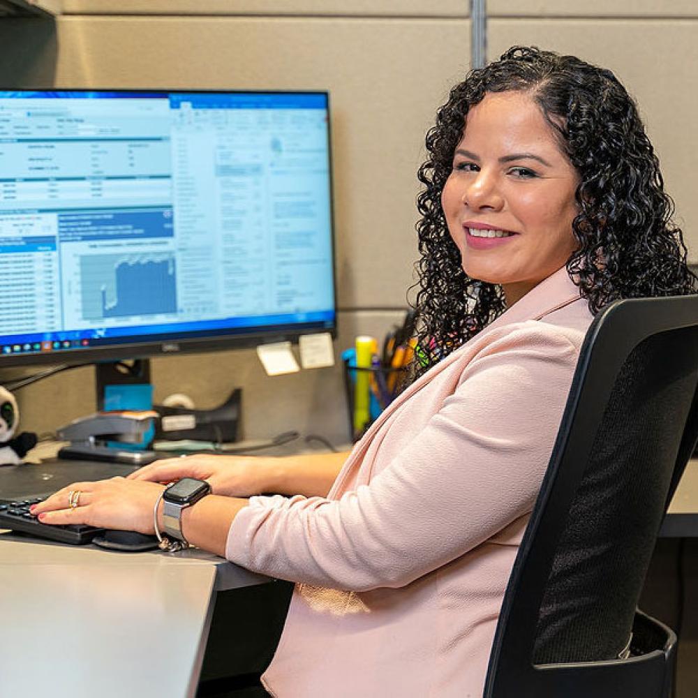 Image of female customer service billing representative at her desk.