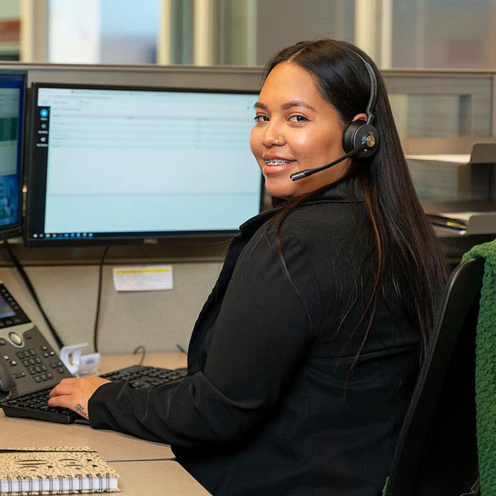 Image of female customer service representative at her desk. 