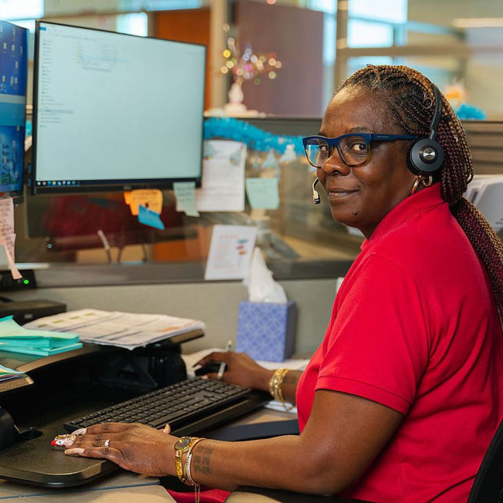 Image of female customer service representative at her desk. 