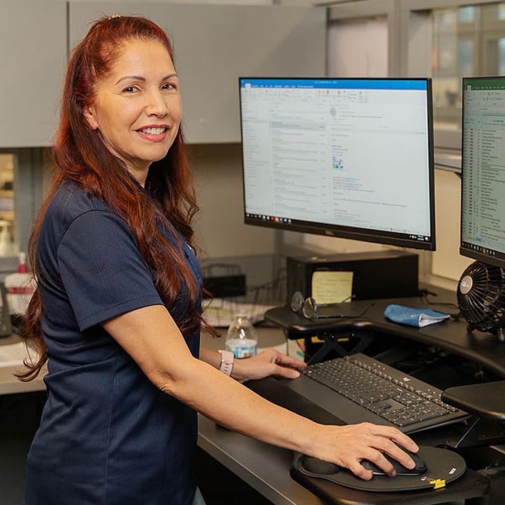 Image of female administrative coordinator at her desk.