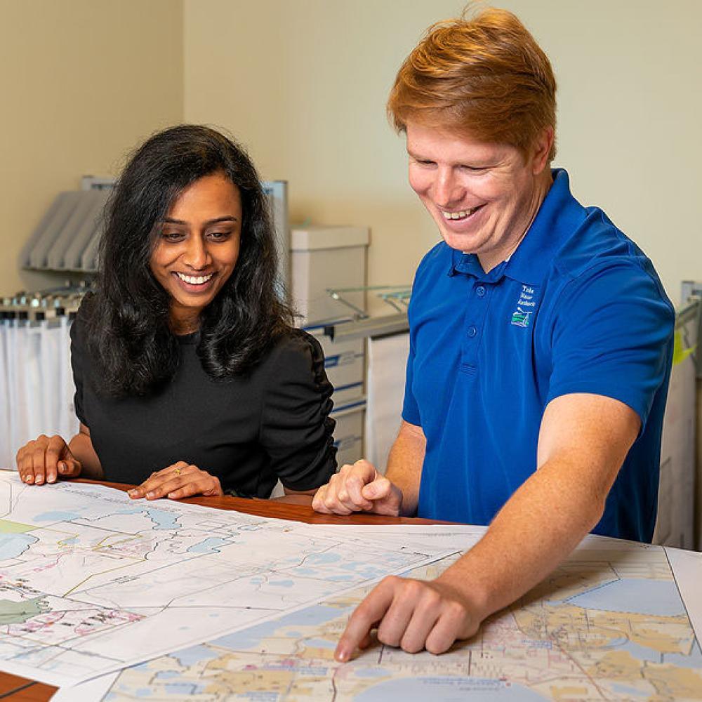 Image of two engineers looking at construction plans.