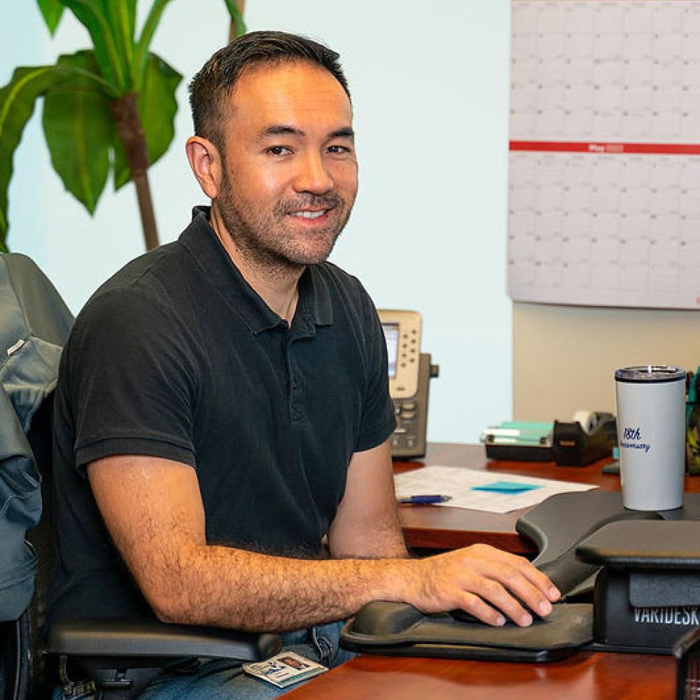 Image of male finance manager sitting at desk. 