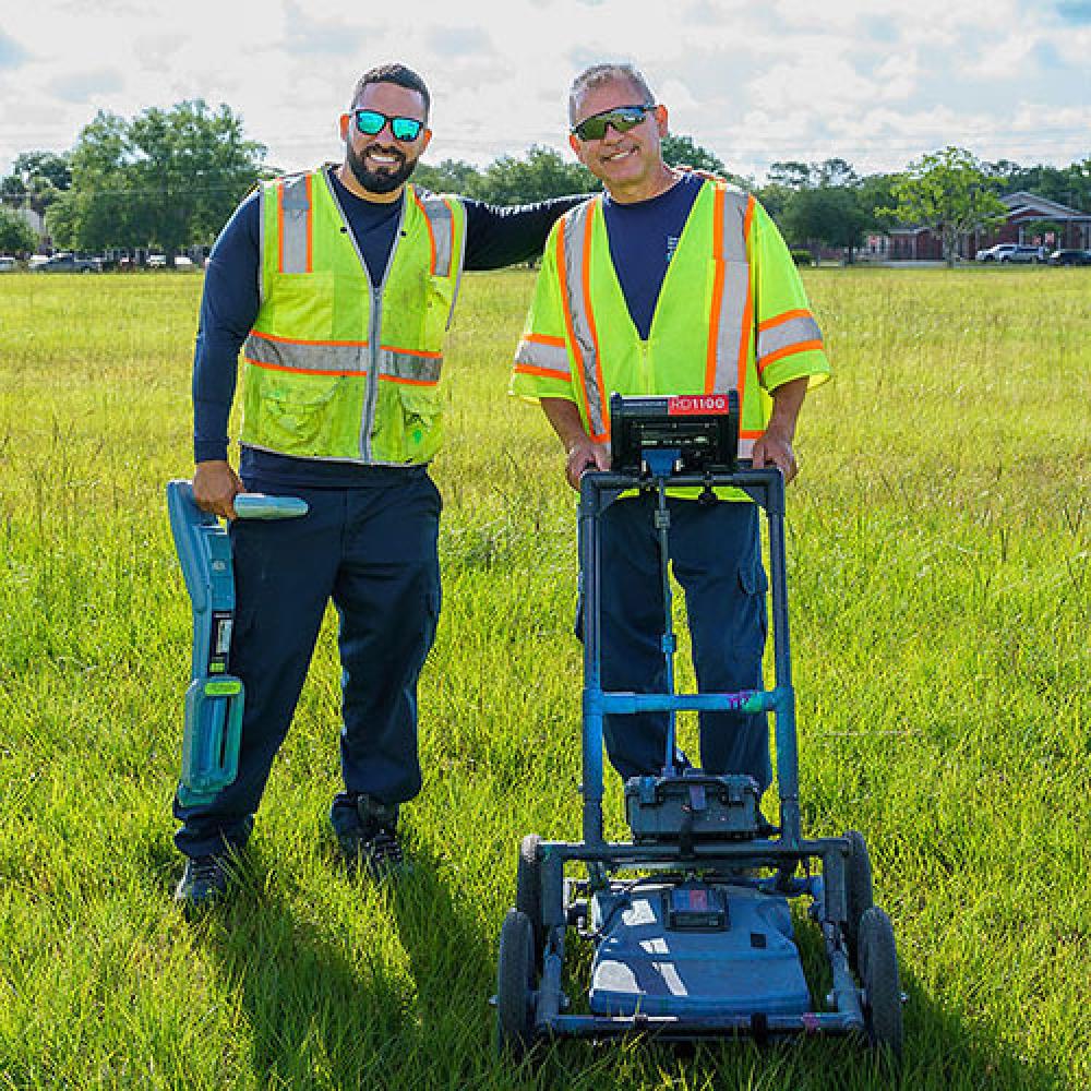 Image of two male locate technicians. 