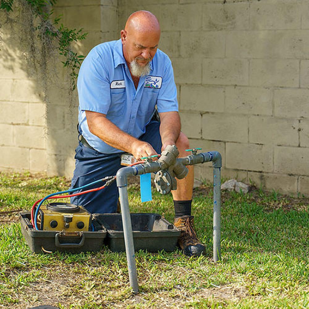 Image of male technician testing a backflow.