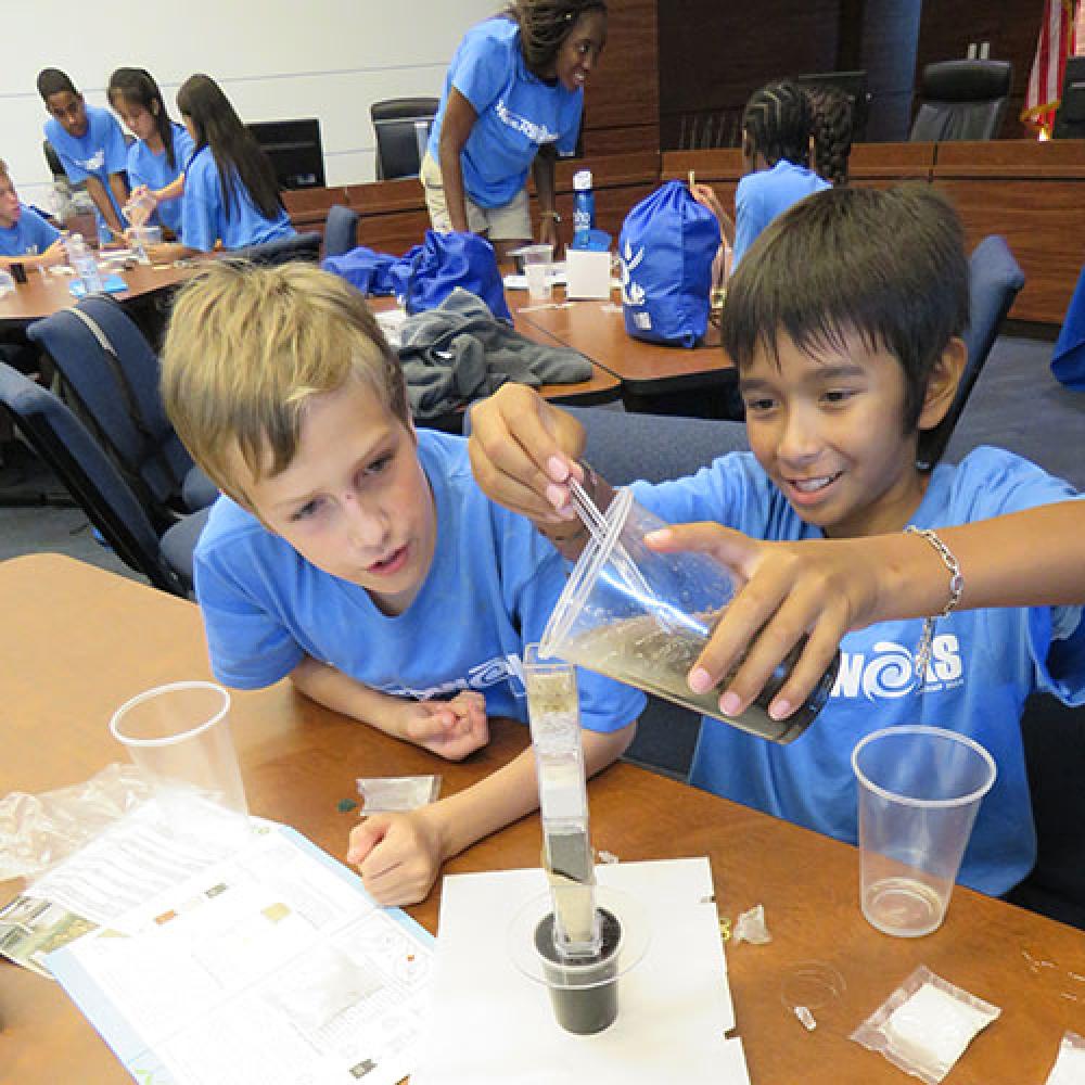 Image of summer campers doing science experiment.