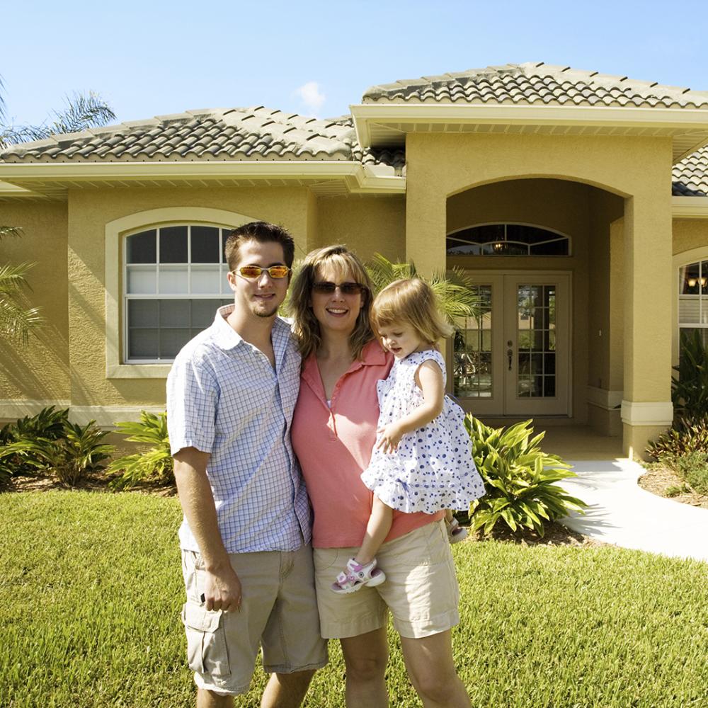 Image of family in front of home.