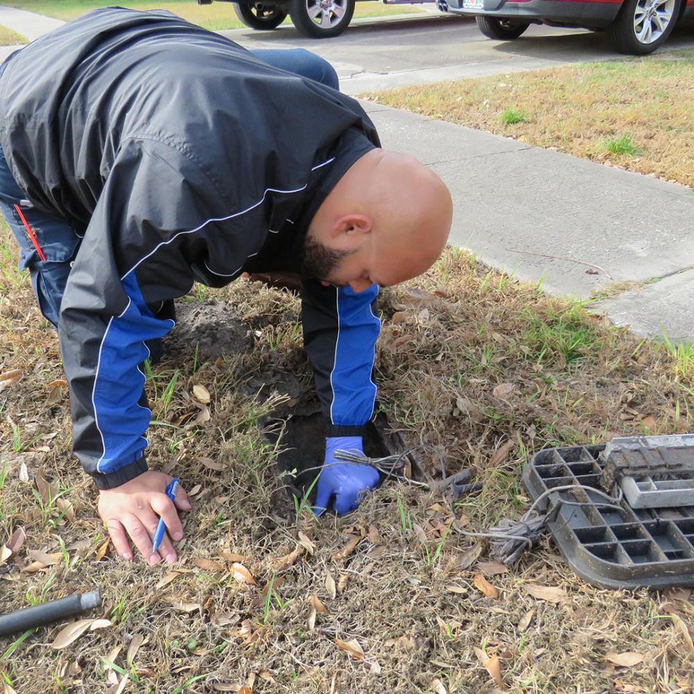 Technician checking inside meter box.