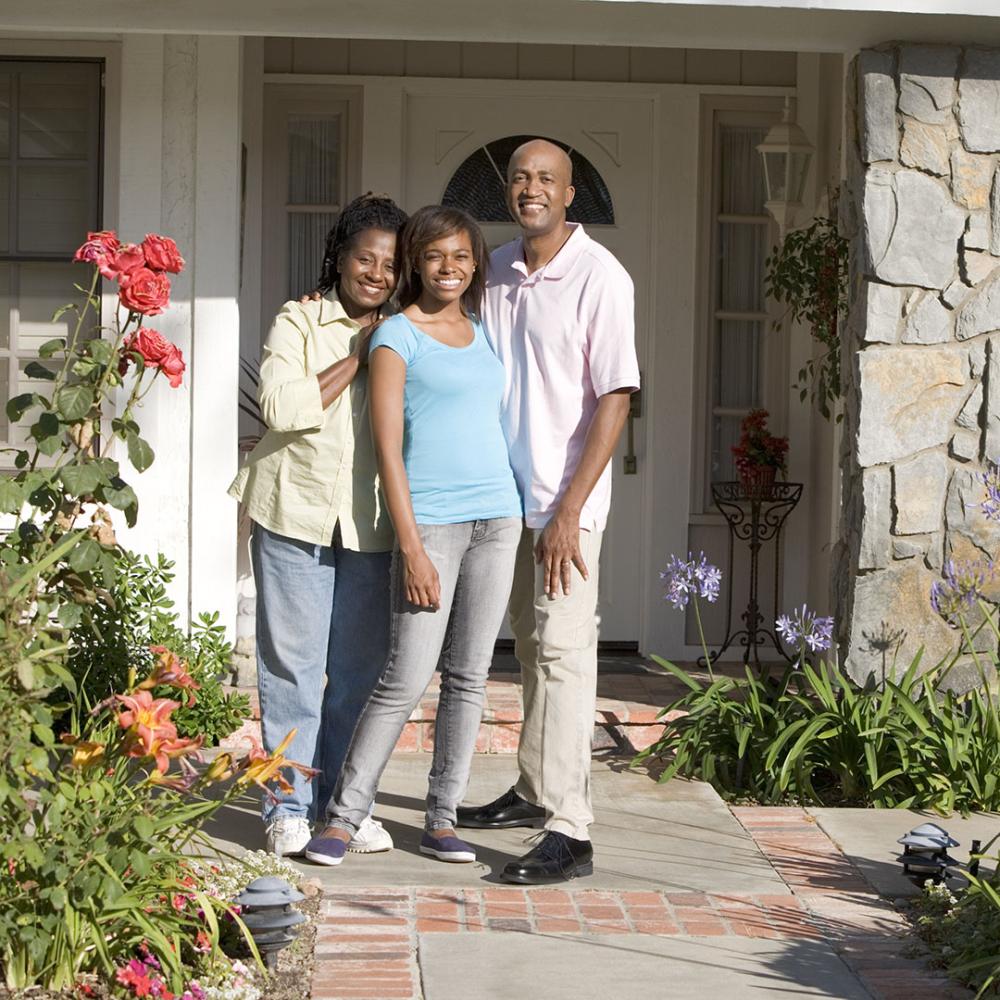 Image of family in front of home.