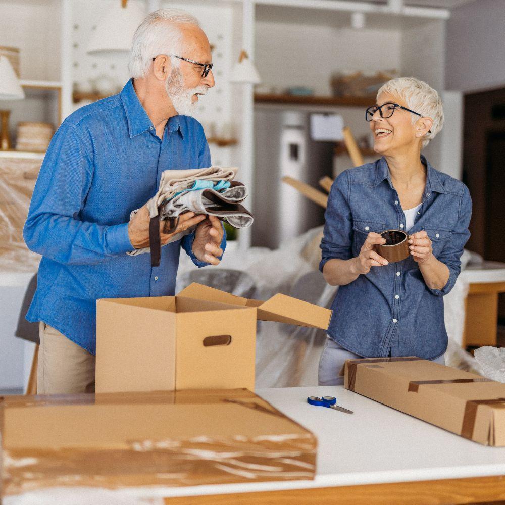 Image shows couple packing boxes. 