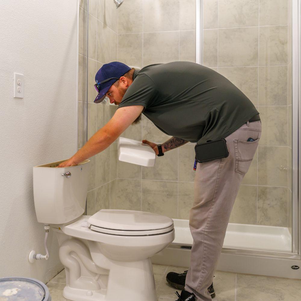 Toho inspector checking toilet. 