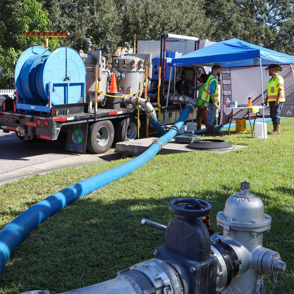 Image of fire hydrant connected to a hose that connects to truck that flushes the water through a filter system.